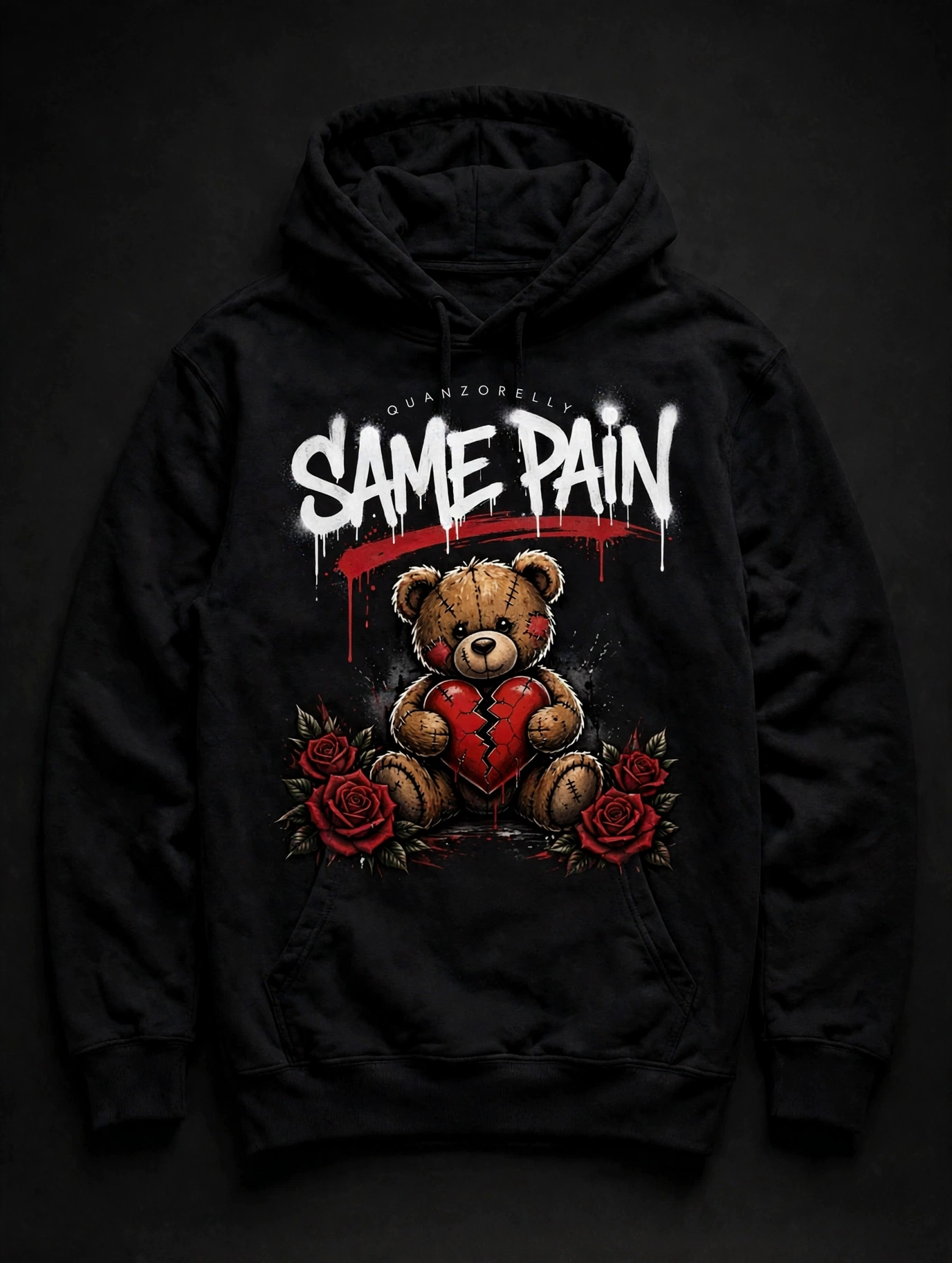 Same Pain hoodie — black hoodie with SAME PAIN in white graffiti lettering, a stitched teddy bear holding a cracked red heart, and red roses